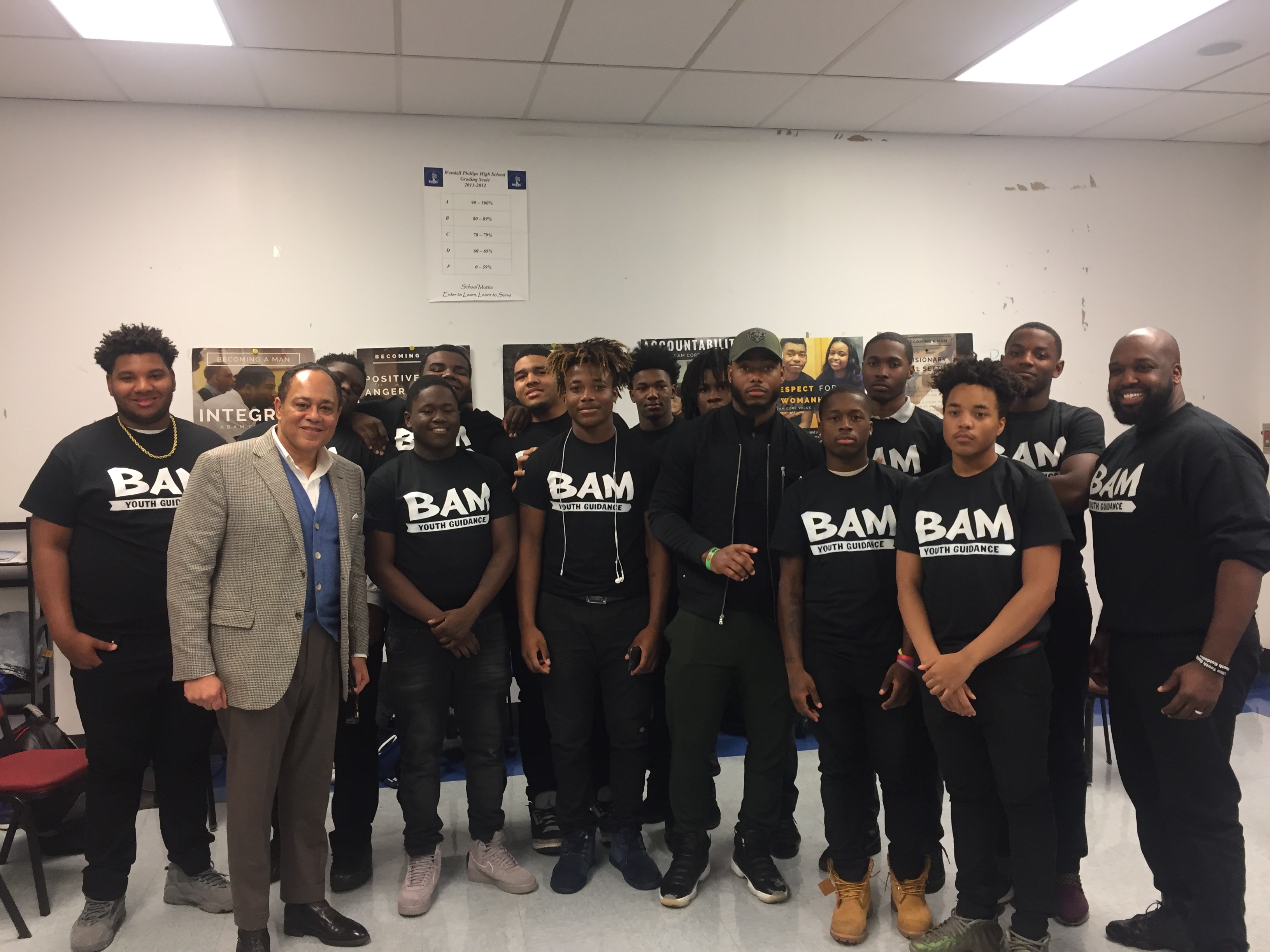 Julian and NFL Safety Adrian Amos (Bears, Packers) share a moment with participants of Chicago-based youth anti-violence program Becoming a Man (BAM)