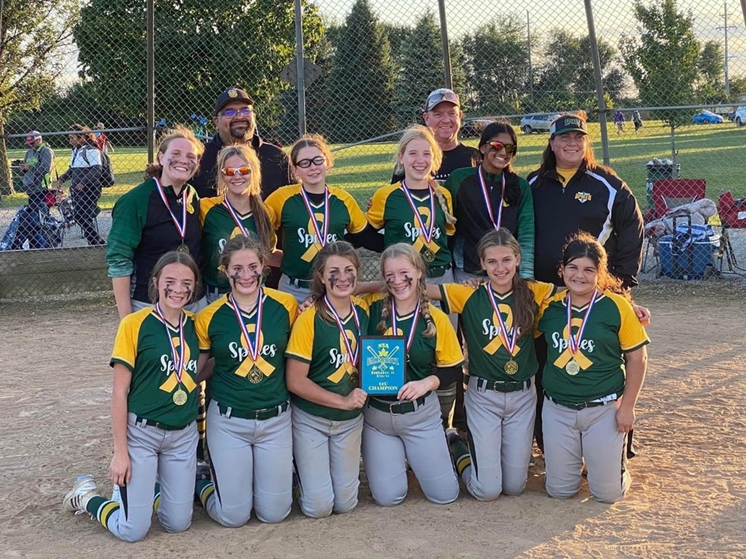 Coach Kooi, far right back row, and the Spikes after a tournament win in September. The team also spent the month raising awareness and funds to fight childhood cancer.