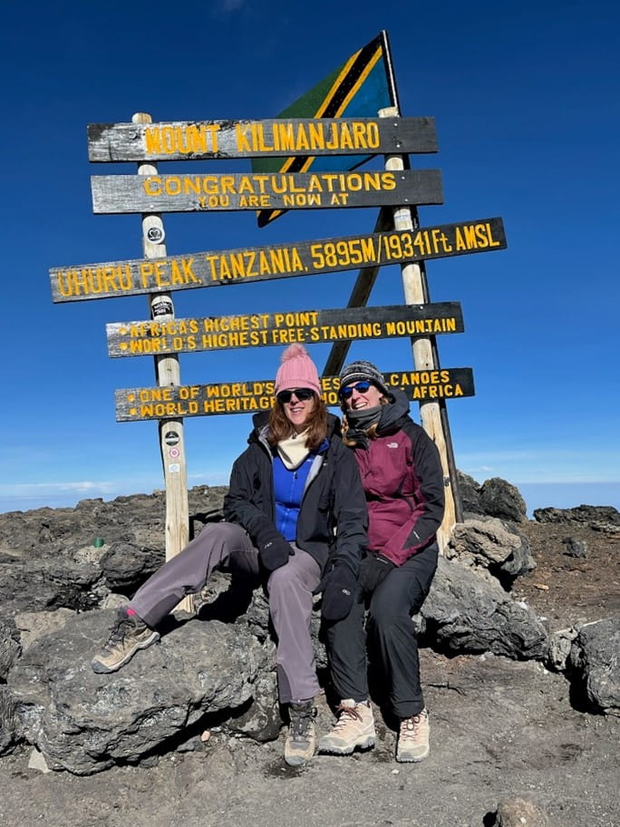 Erin, left, and her climbing partner, Angel, take a breather at Mount Kilimanjaro’s summit.