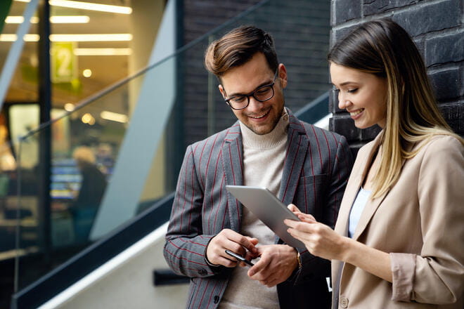 Successful young business people, designer enjoying work together outdoors. Business people tecgnology concept