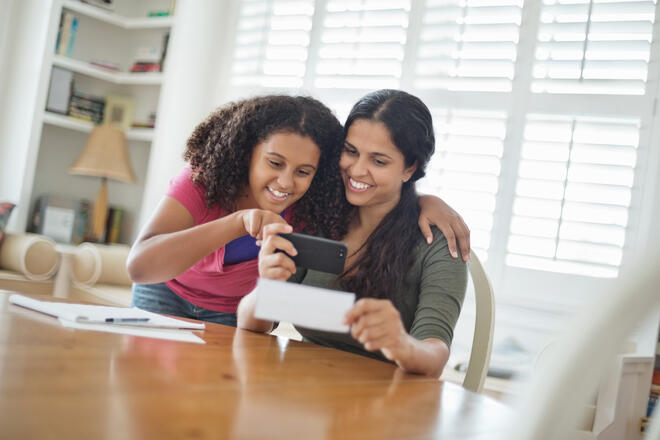 mom and daughter looking at a phone