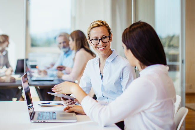 Two coworkers collaborating in an office