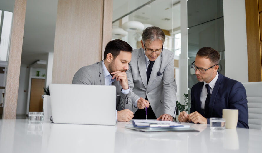 men looking at a laptop