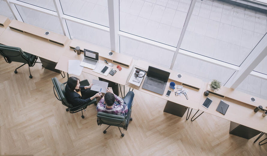 top view Asian Chinese female colleague explaining to her trainee having discussion at office workplace