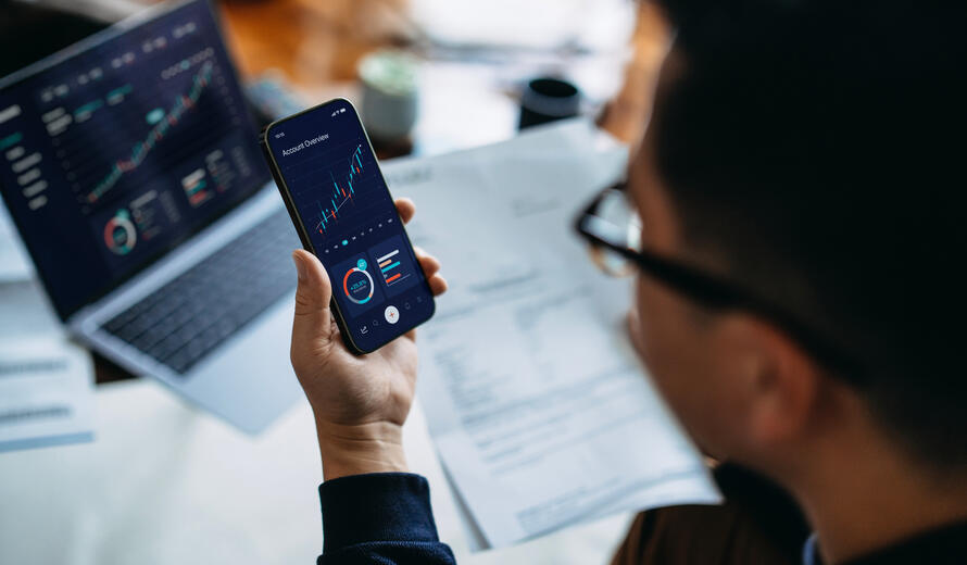 young man managing finance on a smart phone