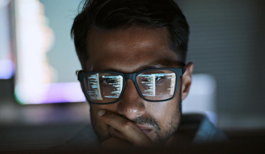 A software engineer working at night on program coding.