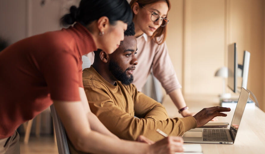 Professionals collaborating at a desk in a modern office setting