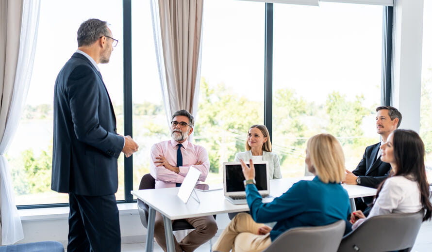 Office meeting with a presenter addressing colleagues.