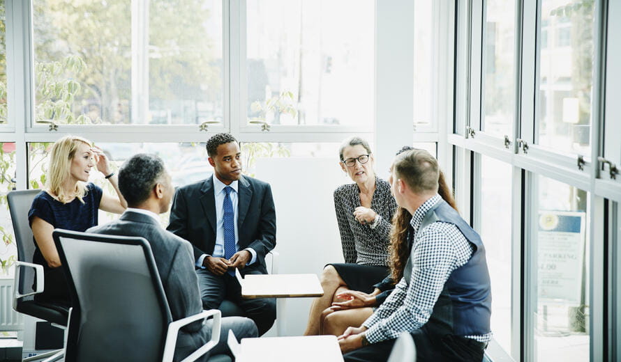 Mature businesswoman leading team meeting in conference room