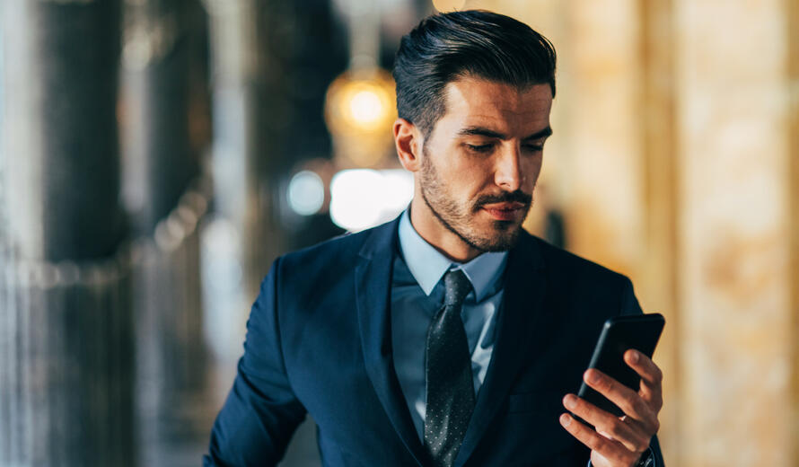 Businessman texting on the phone.