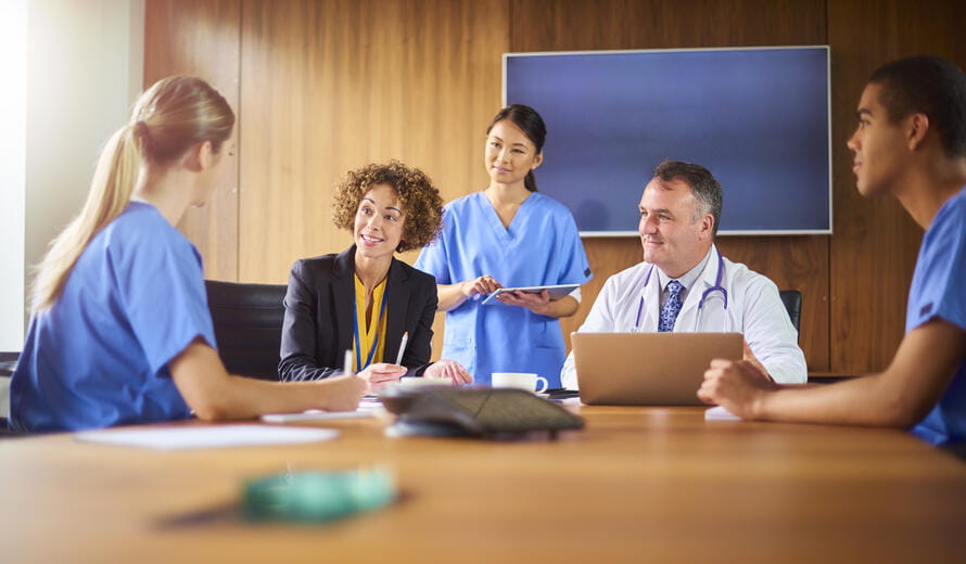 medical team hear presentations from business in the hospital board room