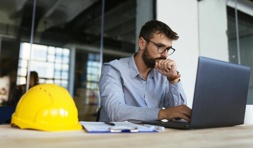 construction worker on a laptop