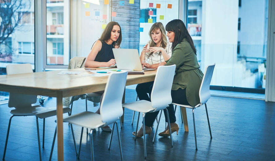 Shot of a group of businesswomen working together on a laptop in an office