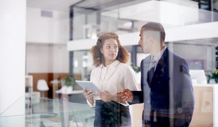 Cropped shot of two businesspeople working together on a digital tablet in an office
