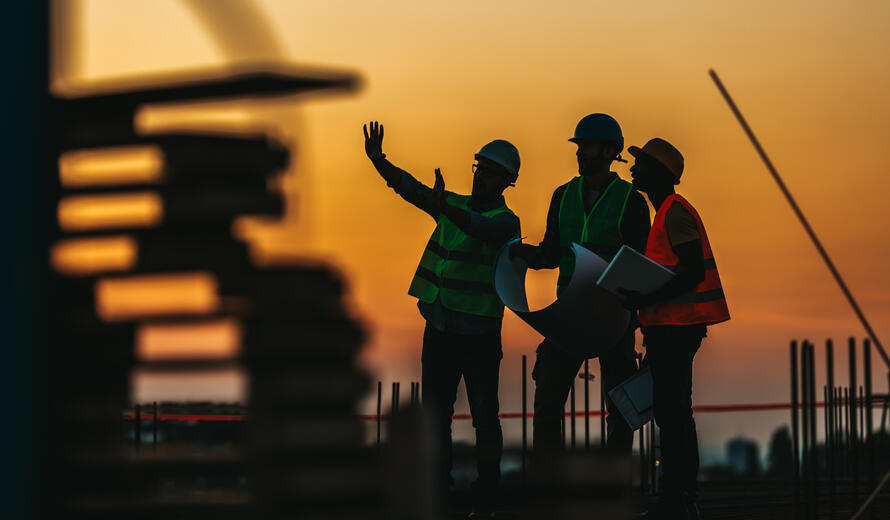 Silhouette Successful male engineer standing survey work on construction