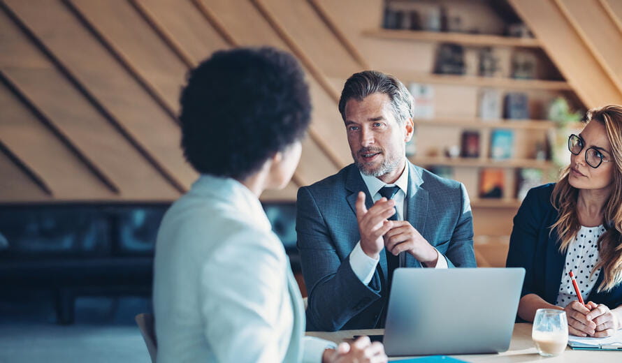 man talking to a women in a meeting
