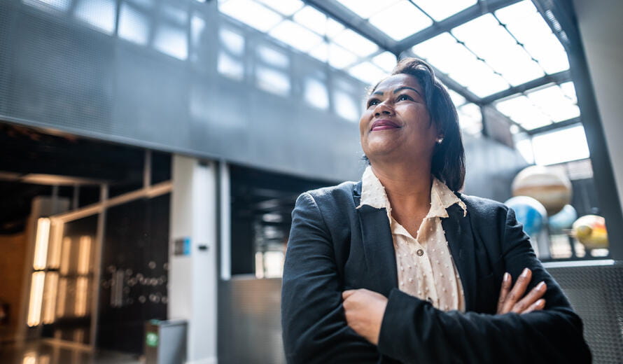 Mature businesswoman contemplating at office lobby