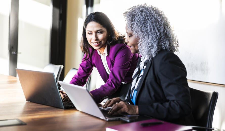 two women on laptops
