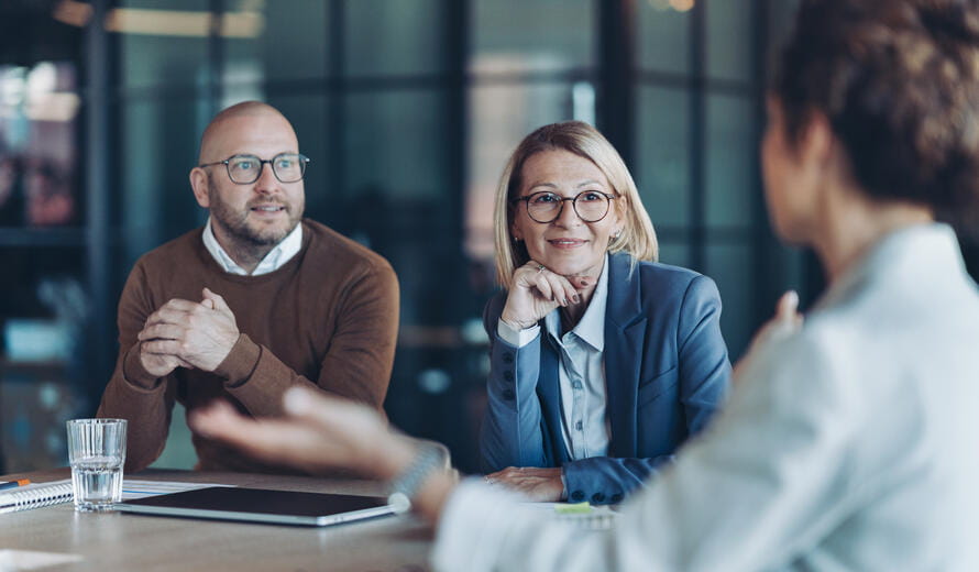 Three business persons talking in the office