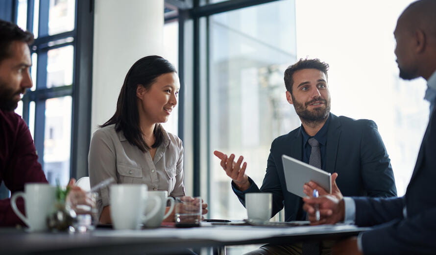 professionals seated together in a corporate meeting setting.