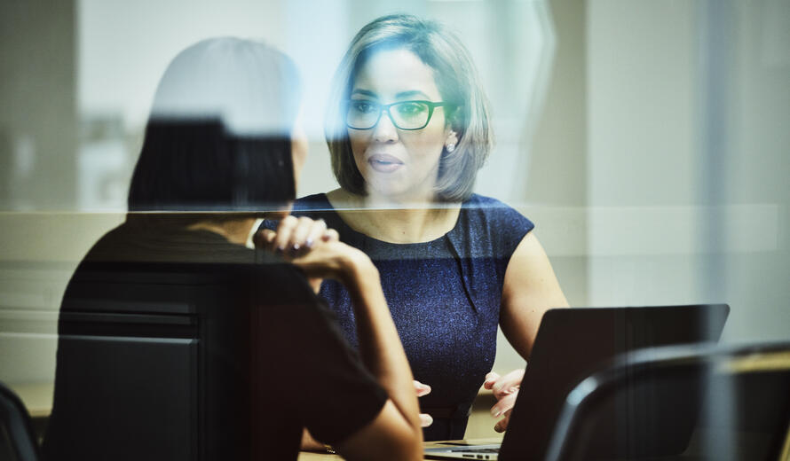 Businesswoman in discussion with client in office conference room
