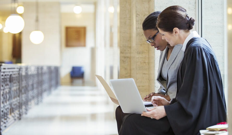 two women on laptops