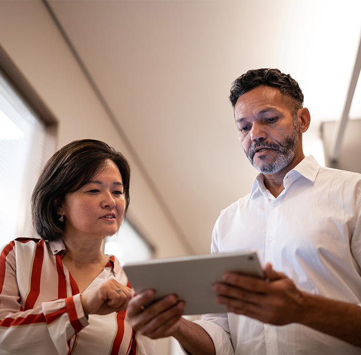 people looking at a tablet