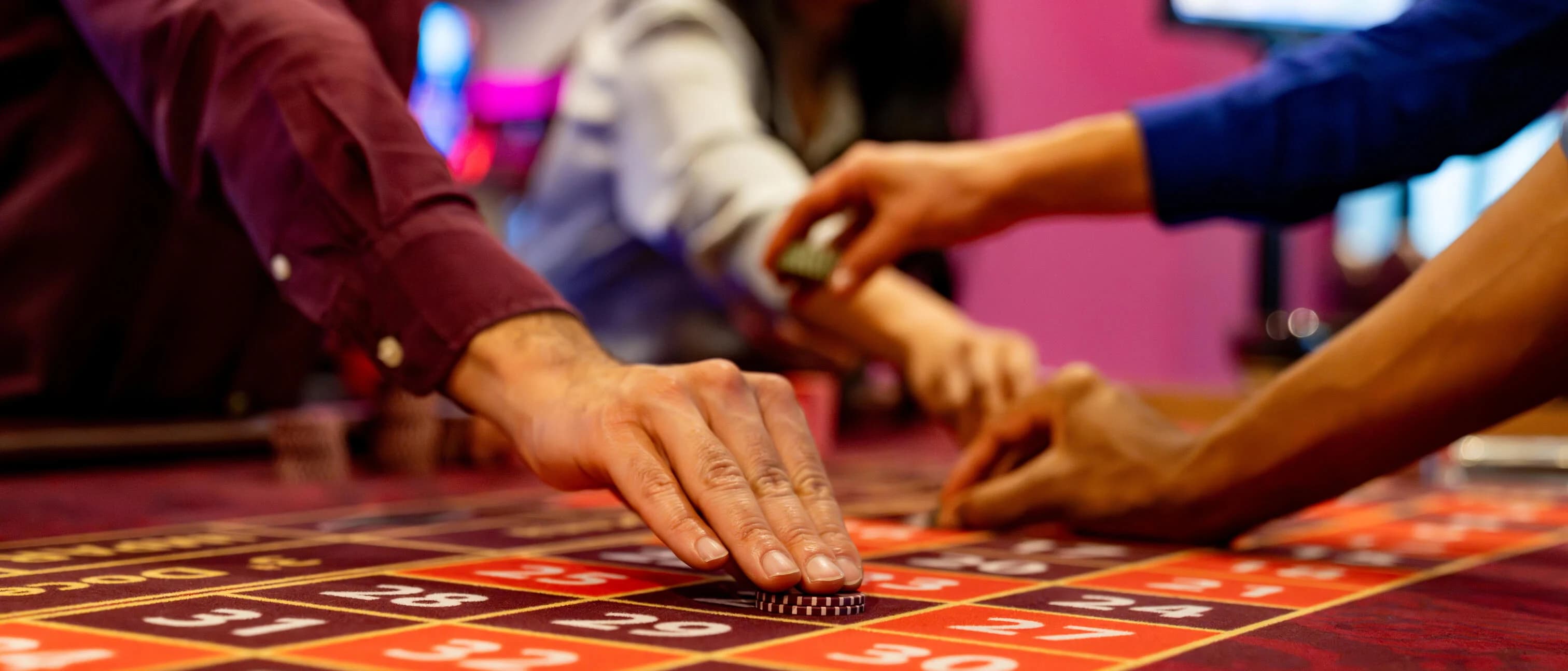 People betting at a craps table