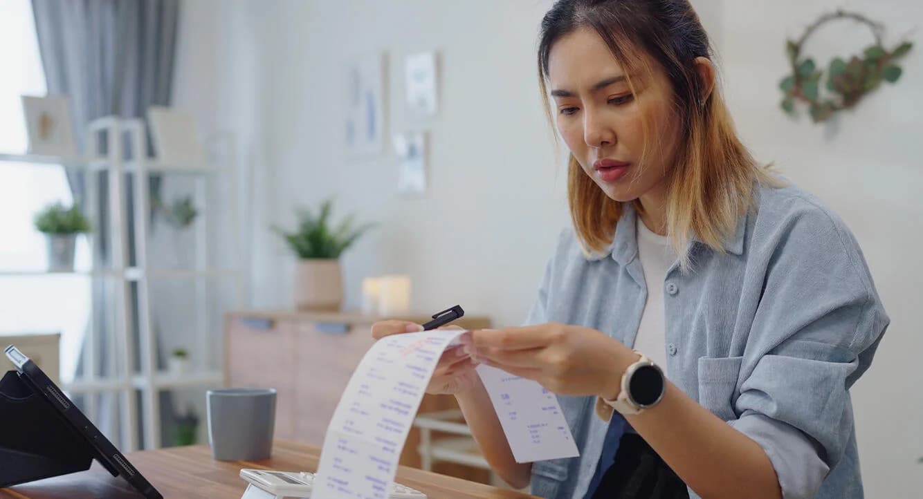 Code42 - a woman looking at a long receipt